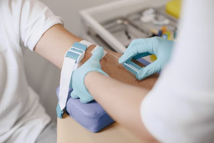 A blood glucose check being performed with a finger-stick meter