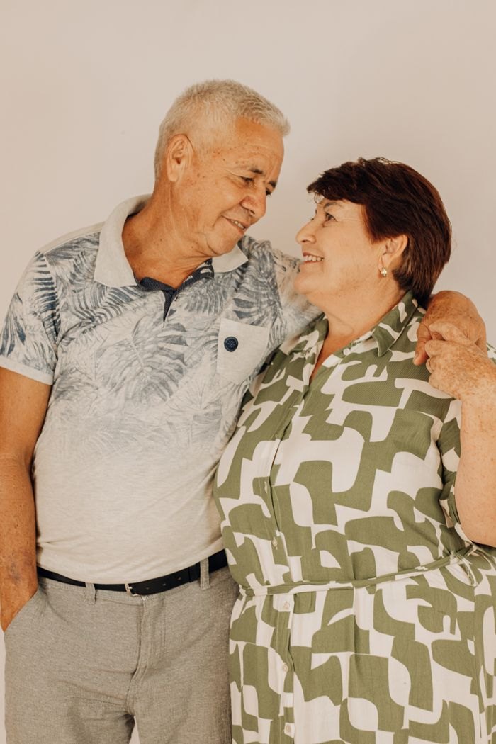 An older couple standing together, smiling