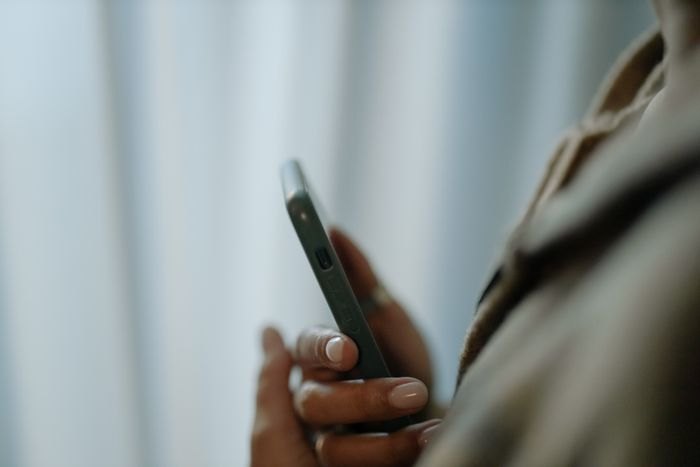 A hand holding a smartphone during a call
